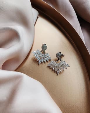 the earrings on a white pillow